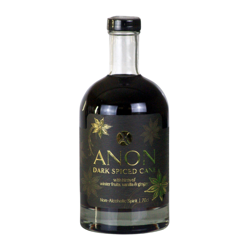A bottle of Anon Dark Spiced cane non-alcoholic spirit, featuring a black label with gold and green botanical illustrations and a black cap, set against a plain white background.