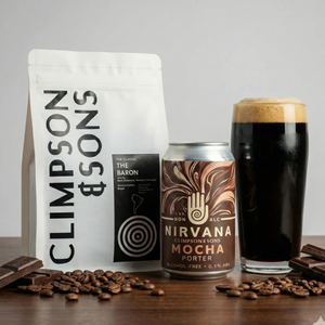 Nirvana Mocha Porter can, Climpson & Sons coffee package, and glass of dark beer on a wooden surface.