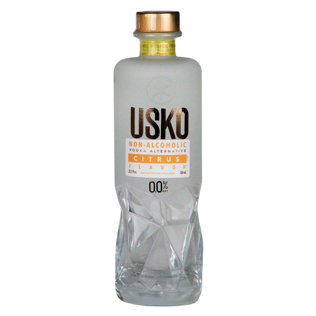 Clear bottle of USKO non-alcoholic drink with a gold cap on a white background