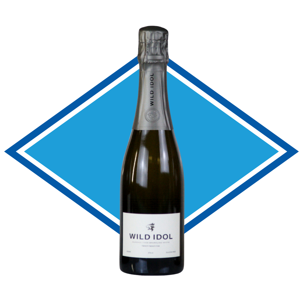 A bottle of Wild Idol Sparkling Wine Non-Alcoholic, set against a graphic blue and white diamond background. Halal certified Alcohol Free Wine